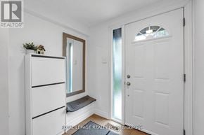 Mississauga (Rathwood) townhouse for rent - A white door with a window in the middle is in a room with white walls.