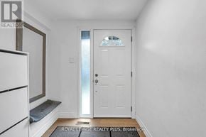 Mississauga (Rathwood) townhouse for rent - A white door with a glass window is in a room with white walls.