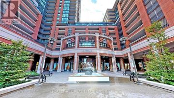 Toronto (Yorkdale-Glen Park) condo for rent - A fountain in the middle of a plaza surrounded by benches and trees.