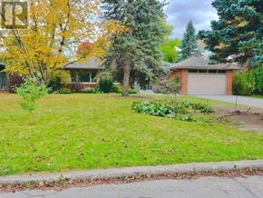 Toronto (St. Andrew-Windfields) apartment for rent - A tree with yellow leaves is in front of a house.