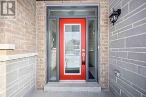 Whitby (Rolling Acres) townhouse for rent - A red door with a glass window is the main focus of the image.