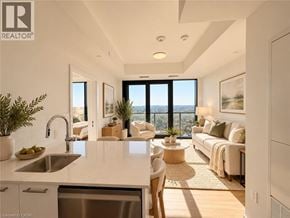 Kitchener condo for rent - A modern kitchen with a dining area and a view of the city.
