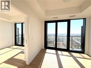 Kitchener condo for rent - A room with a view of the city through large windows.