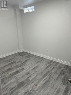 Brampton (Credit Valley) apartment for rent - A room with a wooden floor and white walls.
