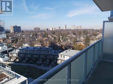 Toronto (Don Valley Village) condo for rent - A view from a balcony overlooking a residential area with buildings and trees.