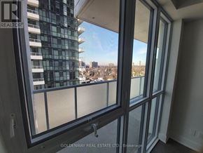 Toronto (Don Valley Village) condo for rent - A view from a window of a cityscape with buildings and trees.