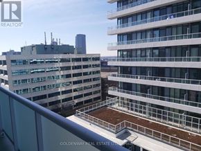Toronto (Don Valley Village) condo for rent - A view of a cityscape from a high-rise building with a balcony.