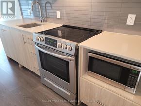 Toronto (Don Valley Village) condo for rent - A modern kitchen with a stainless steel oven and microwave.