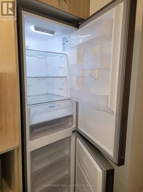 Toronto (Don Valley Village) condo for rent - A refrigerator with the door open showing the empty shelves.