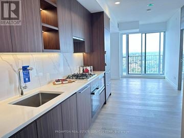 Toronto (Bayview Village) condo for rent - A kitchen with a stove top oven and a sink.