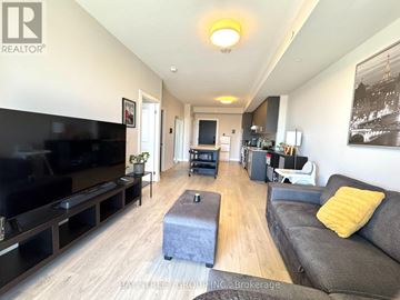 Oakville (Jm Joshua Meadows) condo for rent - A living room with a grey couch and a black television.