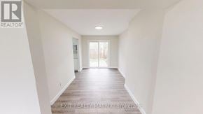 Ottawa townhouse for rent - A long hallway with EXIT REALTY MATRIX Brokerage on the wall.