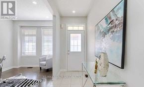 Milton (Fo Ford) apartment for rent - A room with a white chair, a glass table, and a painting on the wall.