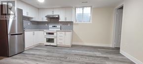 Mississauga (Meadowvale) apartment for rent - A kitchen with a refrigerator, oven, and cabinets.