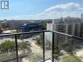 Mississauga (Cooksville) condo for rent - A balcony view of a city street with buildings and cars.