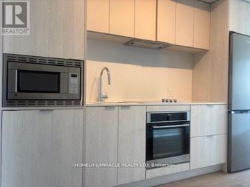 Mississauga (Cooksville) condo for rent - A kitchen with a microwave, oven, and sink.
