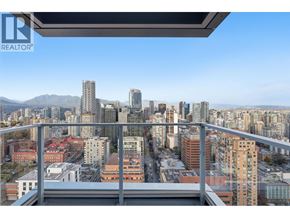 Vancouver apartment for rent - A cityscape with a mountain range in the background.