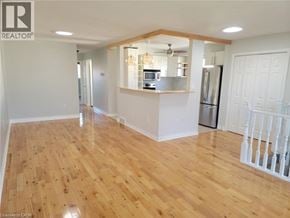 St. Catharines apartment for rent - A kitchen area with wooden floors and white walls.