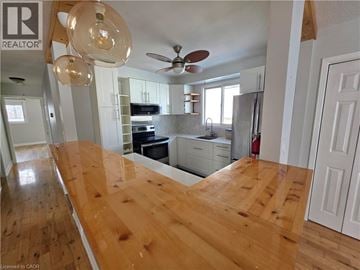 St. Catharines apartment for rent - A kitchen with a wooden counter top and a ceiling fan.