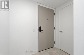 Toronto (Leaside) condo for rent - A white door with a black handle is in a room with white walls.