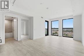 Toronto (Leaside) condo for rent - A spacious room with a view of the cityscape through the windows.