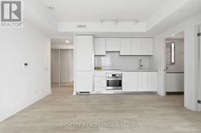 Toronto (Leaside) condo for rent - A white kitchen with a refrigerator, oven, and cabinets.