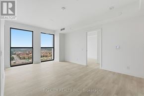Toronto (Leaside) condo for rent - A room with a view of a cityscape through the windows.