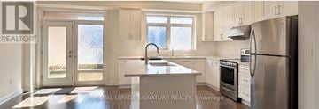 Vaughan (Beverley Glen) townhouse for rent - A kitchen with white cabinets and a stainless steel refrigerator.