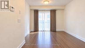 Vaughan (Beverley Glen) townhouse for rent - A room with a wooden floor and a window with curtains.