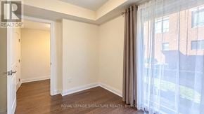 Vaughan (Beverley Glen) townhouse for rent - A room with a door leading to another room and a window with curtains.