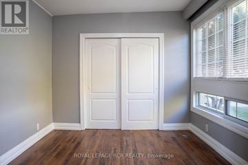 Bradford West Gwillimbury (Bradford) fourplex for rent - A room with a white door and a window with blinds.