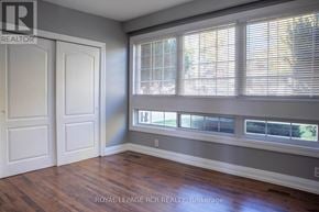 Bradford West Gwillimbury (Bradford) fourplex for rent - A room with a white door and a window with blinds.