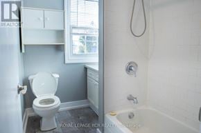 Bradford West Gwillimbury (Bradford) fourplex for rent - A white toilet is in a bathroom with a white tub.