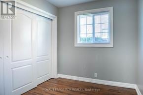 Bradford West Gwillimbury (Bradford) fourplex for rent - A white door is on the left and a window with blinds is on the right in a room.
