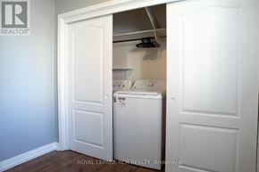 Bradford West Gwillimbury (Bradford) fourplex for rent - A white washing machine is in a small laundry room.