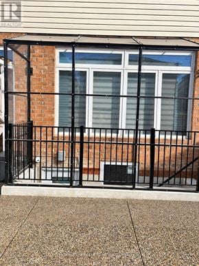 Hamilton (Stoney Creek Mountain) apartment for rent - A black metal fence surrounds a brick building.