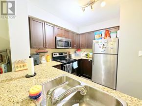 Toronto (Dovercourt-Wallace Emerson-Junction) condo for rent - A kitchen with granite countertops and stainless steel appliances.