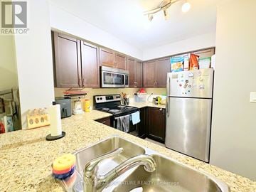 Toronto (Dovercourt-Wallace Emerson-Junction) condo for rent - A kitchen with granite countertops and stainless steel appliances.