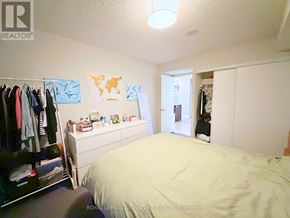 Toronto (Dovercourt-Wallace Emerson-Junction) condo for rent - A bedroom with a bed, a wardrobe, and a dresser.