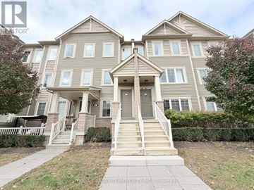 Oshawa (Windfields) townhouse for rent - A two-story residential building with a front porch and a front yard.