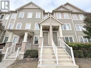 Oshawa (Windfields) townhouse for rent - A two-story residential building with a front porch.