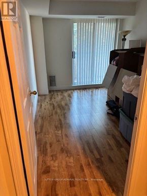 Vaughan (Crestwood-Springfarm-Yorkhill) condo for rent - A hallway with wooden floors and a door on the left.