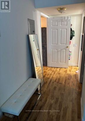 Vaughan (Crestwood-Springfarm-Yorkhill) condo for rent - A hallway with a white door and a mirror on the wall.