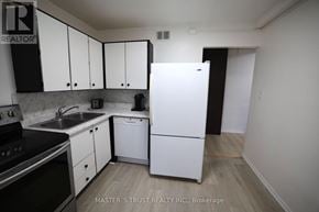 Waterloo condo for rent - A kitchen with white appliances and cabinets.