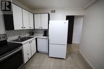 Waterloo condo for rent - A kitchen with white appliances and cabinets.