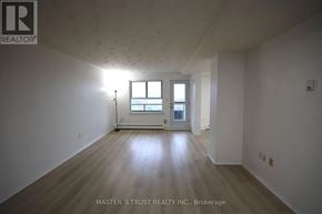 Waterloo condo for rent - A large empty room with wooden floors and white walls.