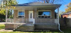 Toronto (Wexford-Maryvale) apartment for rent - A small house with a porch and a sign that says "Homelife Landmark Realty Inc., Brokerage.".