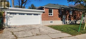 Toronto (Wexford-Maryvale) apartment for rent - A garage with a white door is in front of a brick house.
