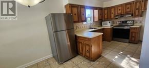 Toronto (Wexford-Maryvale) apartment for rent - A kitchen with a refrigerator, stove, and oven.