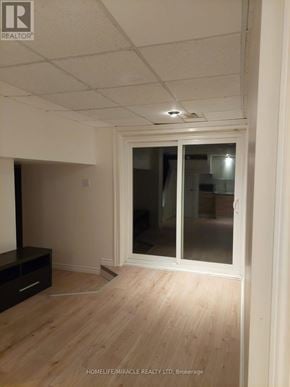 Oshawa (Donevan) apartment for rent - A room with a sliding glass door and wooden flooring.